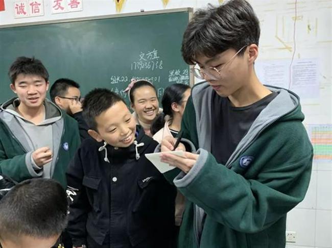 A group of people standing around each other

Description automatically generated