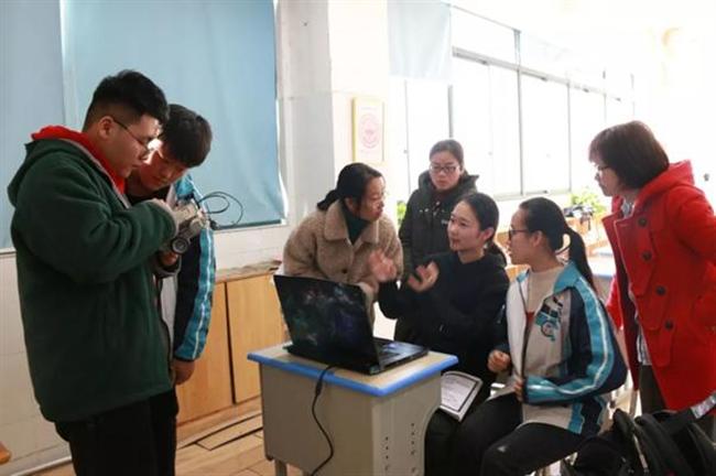 A group of people standing in a room

Description automatically generated