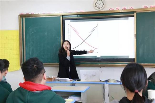 A group of people sitting at a desk

Description automatically generated